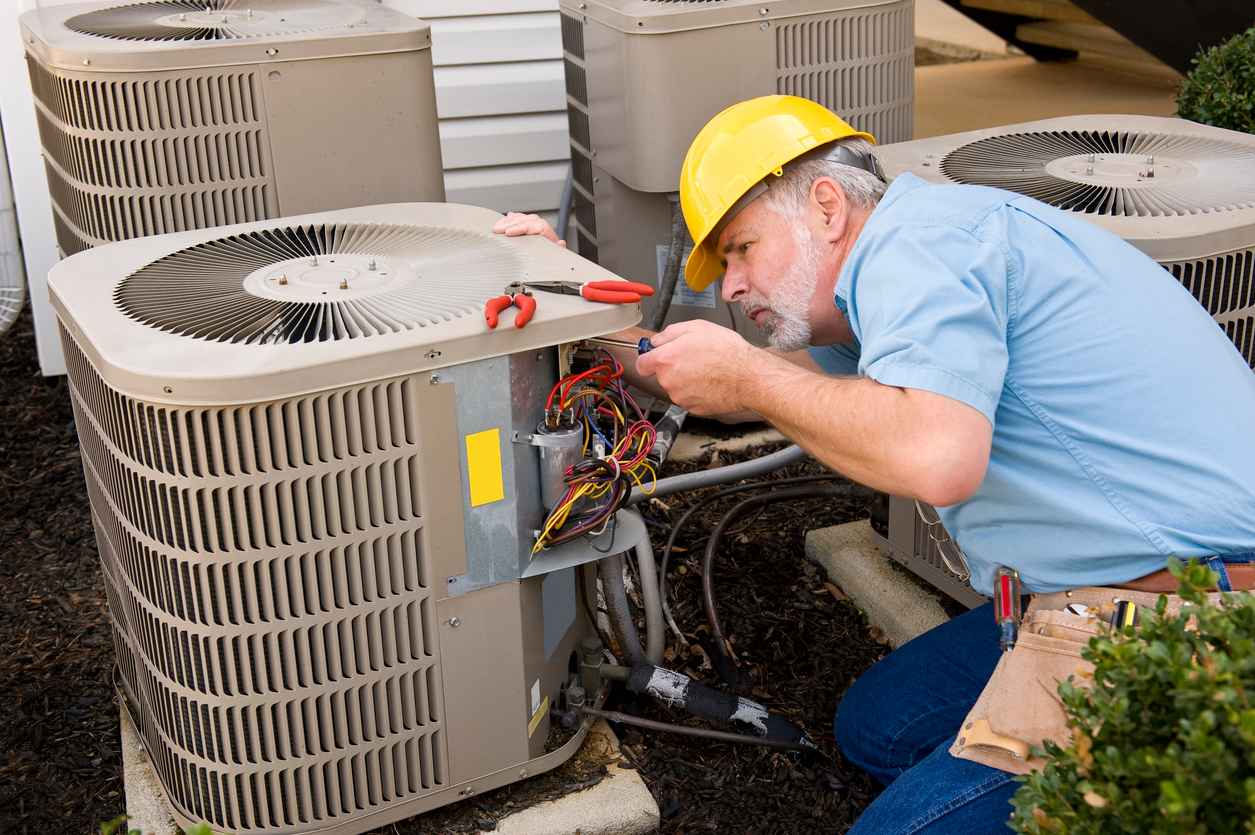 HVAC technician working on an AC unit