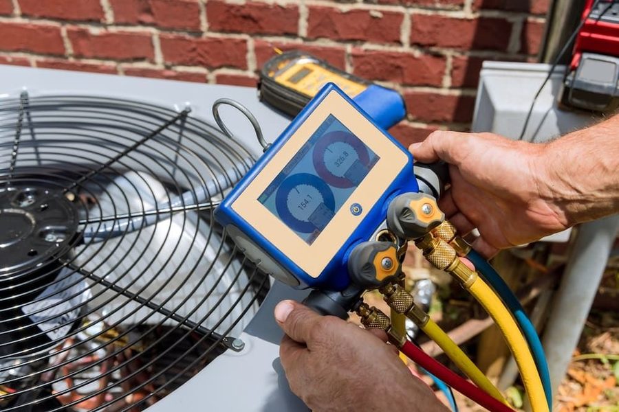 HVAC technician performing maintenance on outside unit