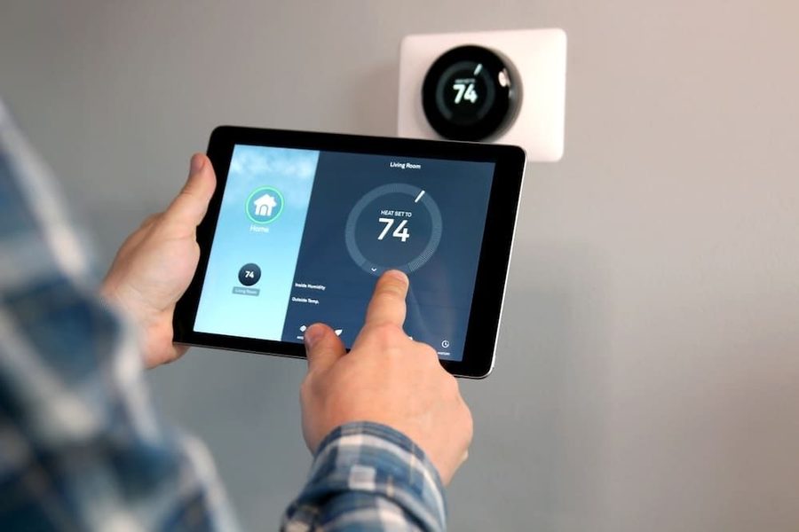 Homeowner adjusting the smart thermostat in their home on a tablet