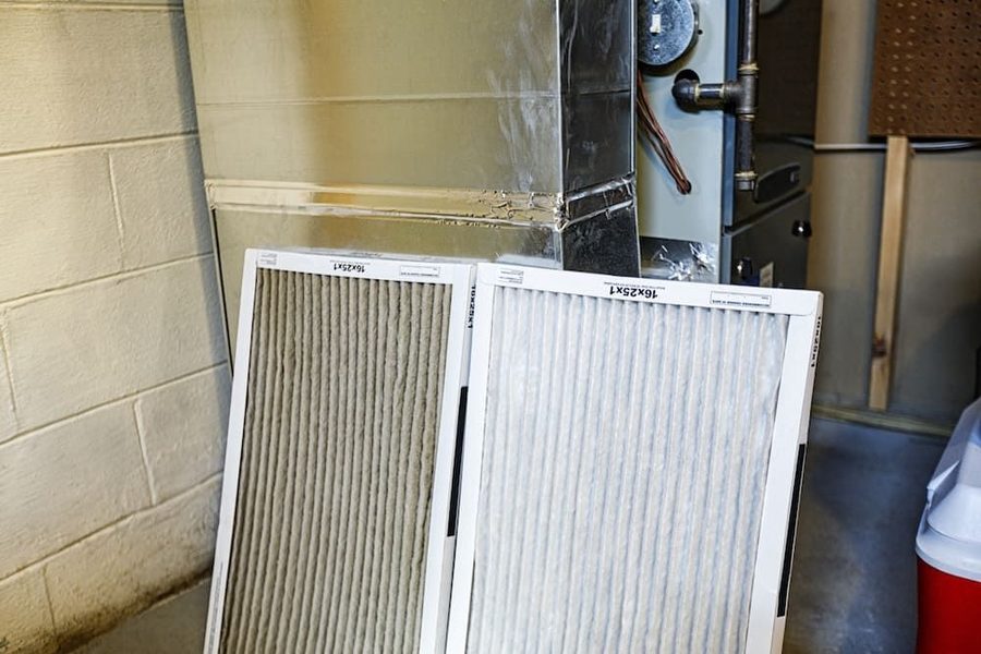 The filter being replaced for a furnace as part of routine maintenance